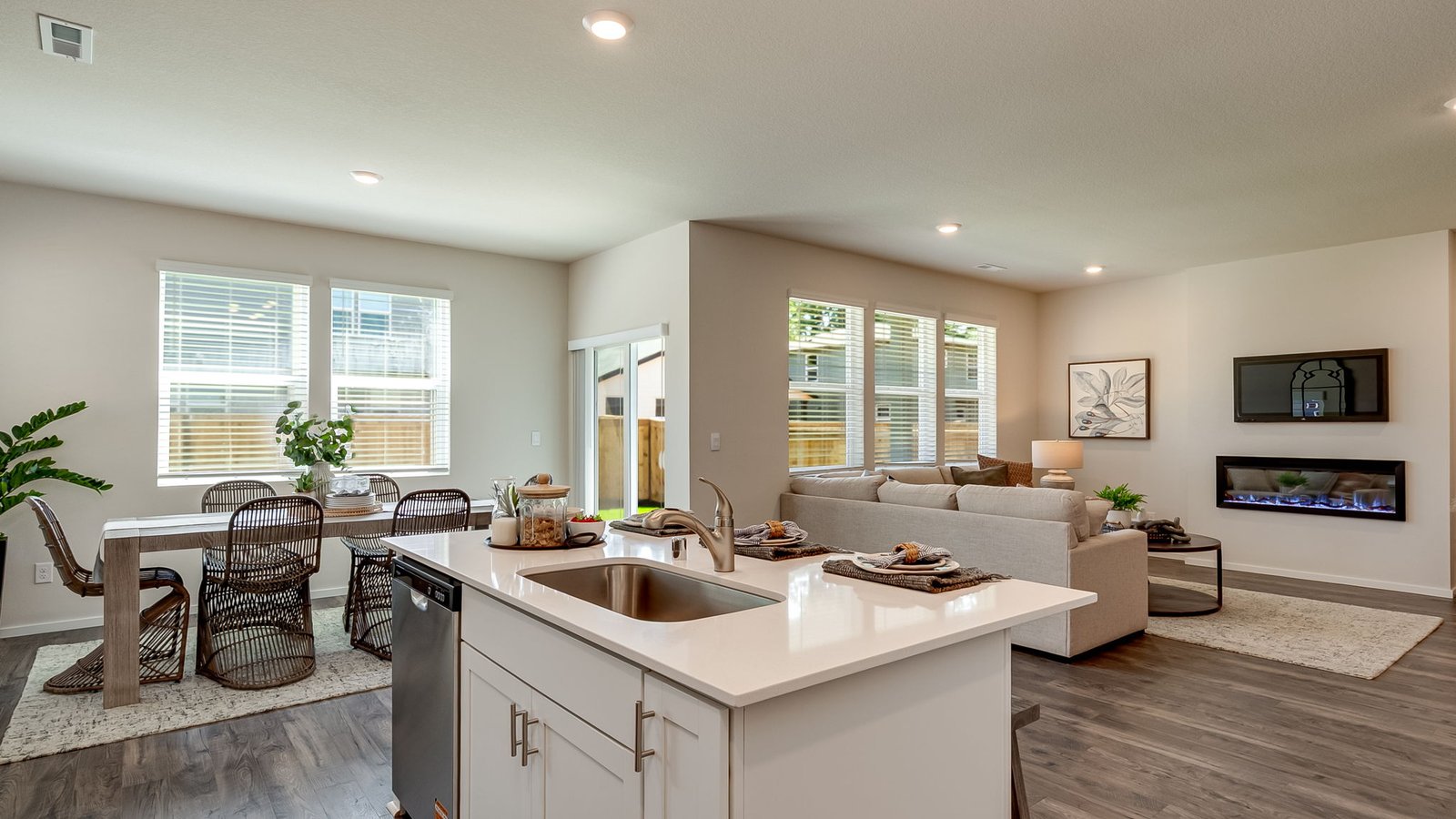 Kitchen with shaker cabinets, quartz counters, stainless steel appliances, pantry, and an island with a breakfast bar