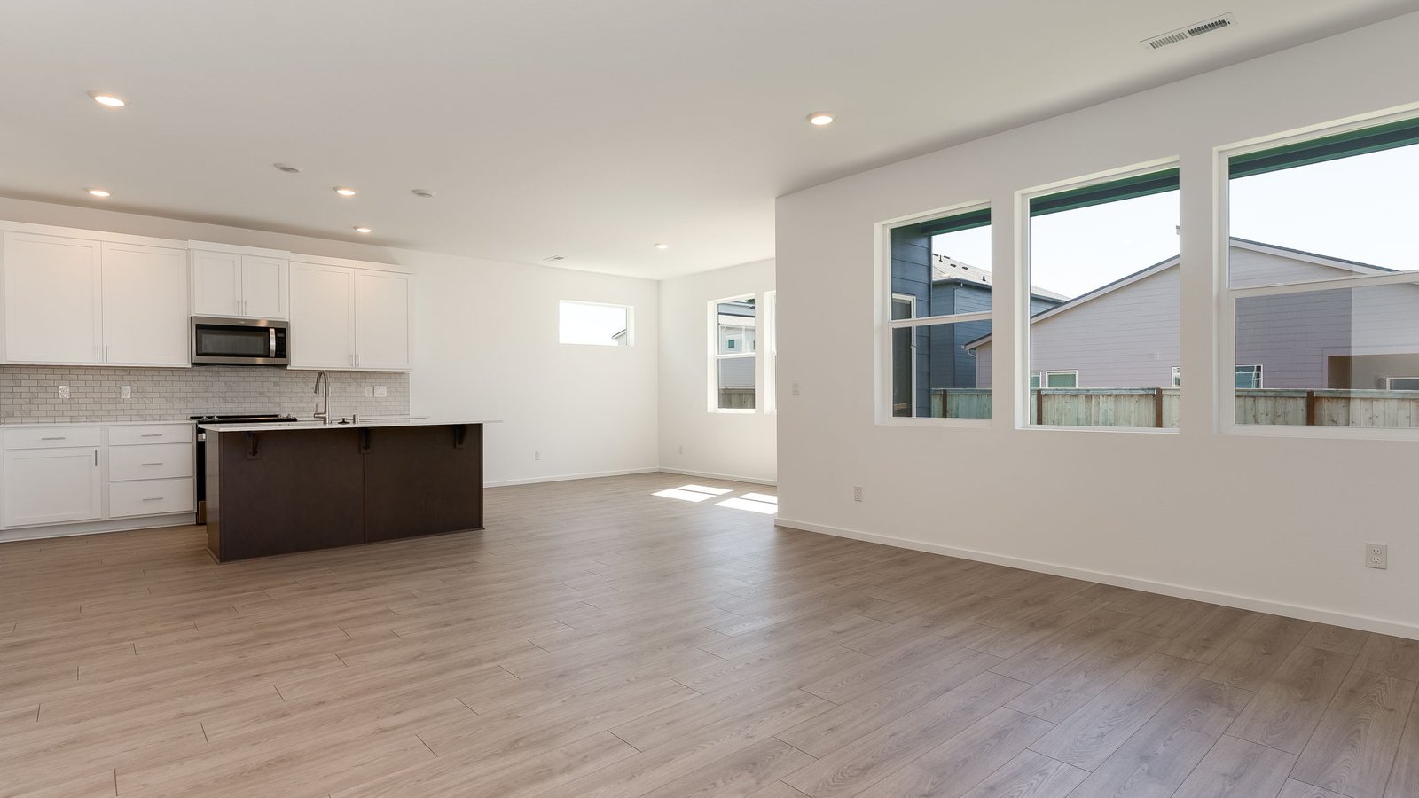 Great room with laminate flooring and an electric fireplace