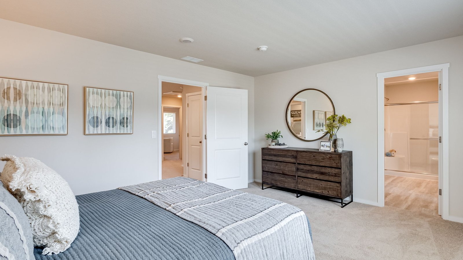 Primary bedroom with wall-to-wall carpet, a walk-in closet and an attached bathroom