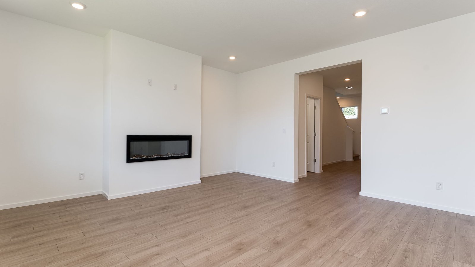 Great room with laminate flooring and an electric fireplace
