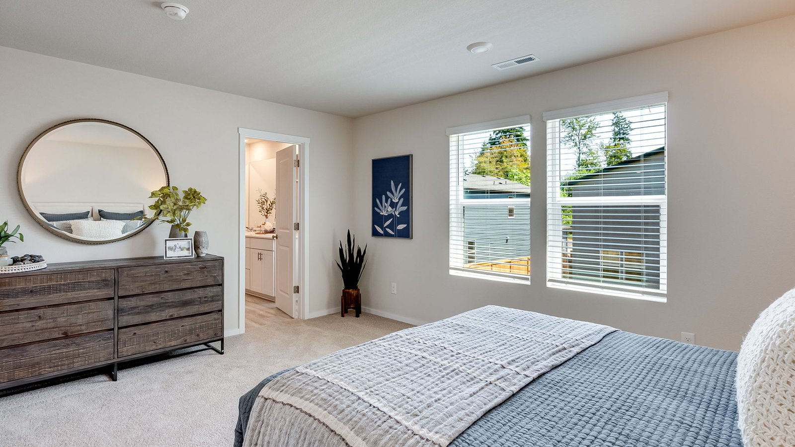 Primary bedroom with wall-to-wall carpet, a walk-in closet and an attached bathroom