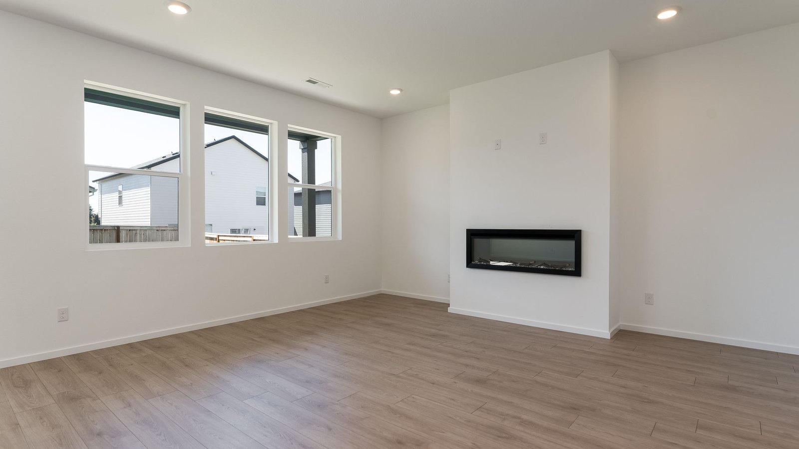 Great room with laminate flooring and an electric fireplace