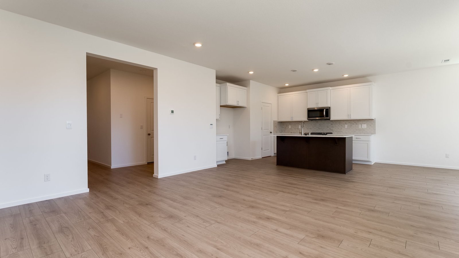 Great room with laminate flooring and an electric fireplace