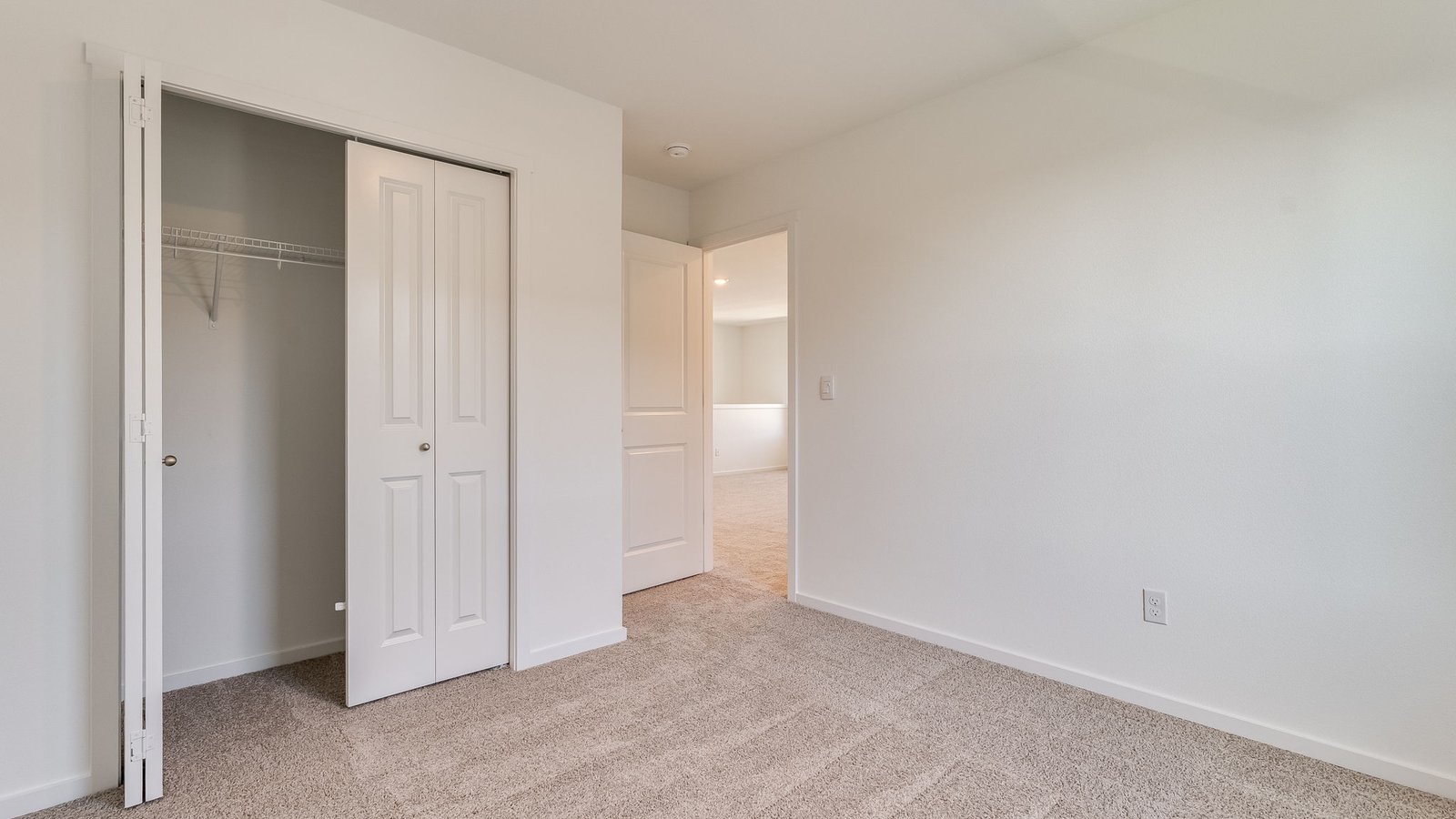 Bedroom with wall-to-wall carpet and a closet