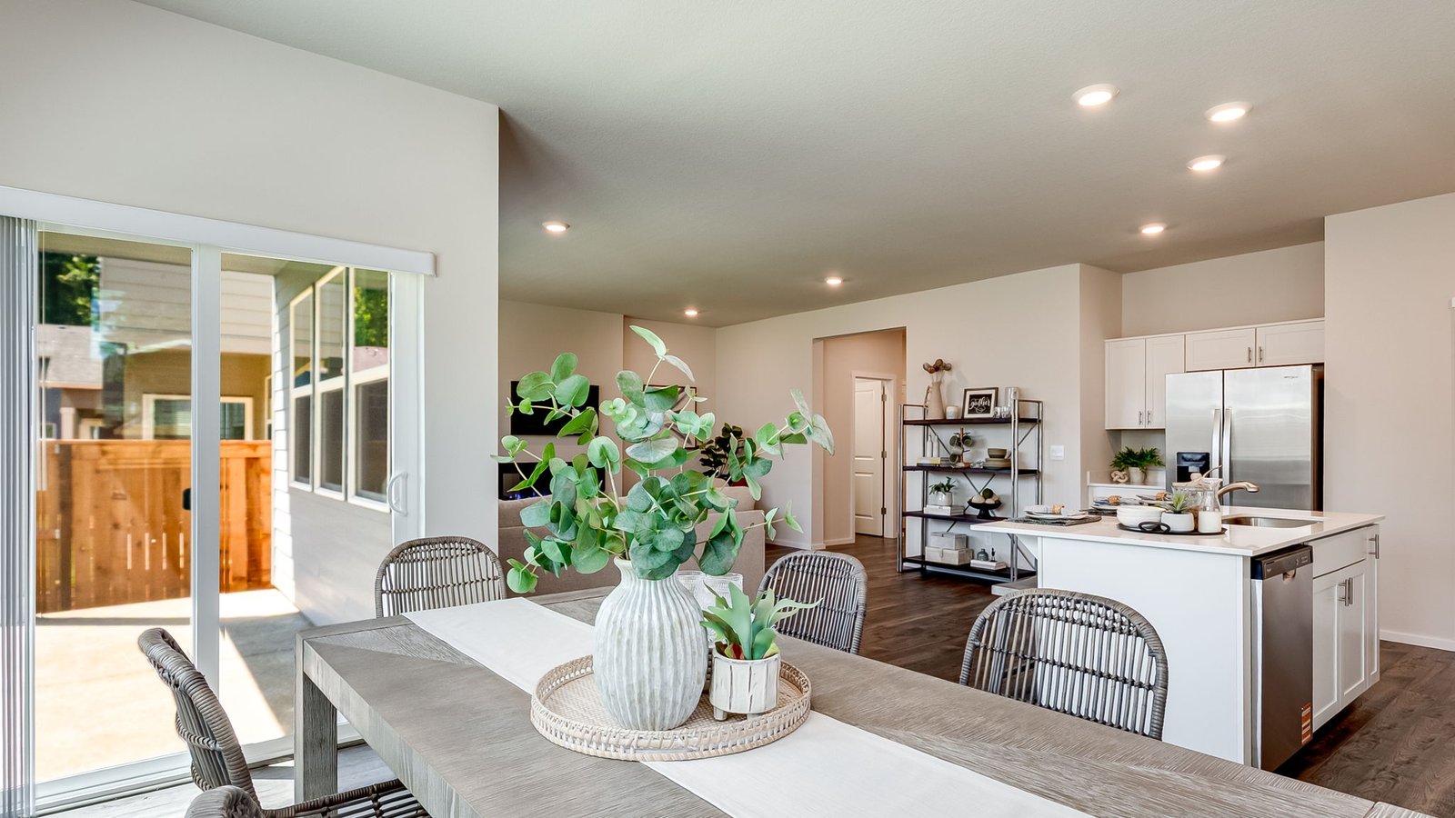 Kitchen with shaker cabinets, quartz counters, stainless steel appliances, pantry, and an island with a breakfast bar