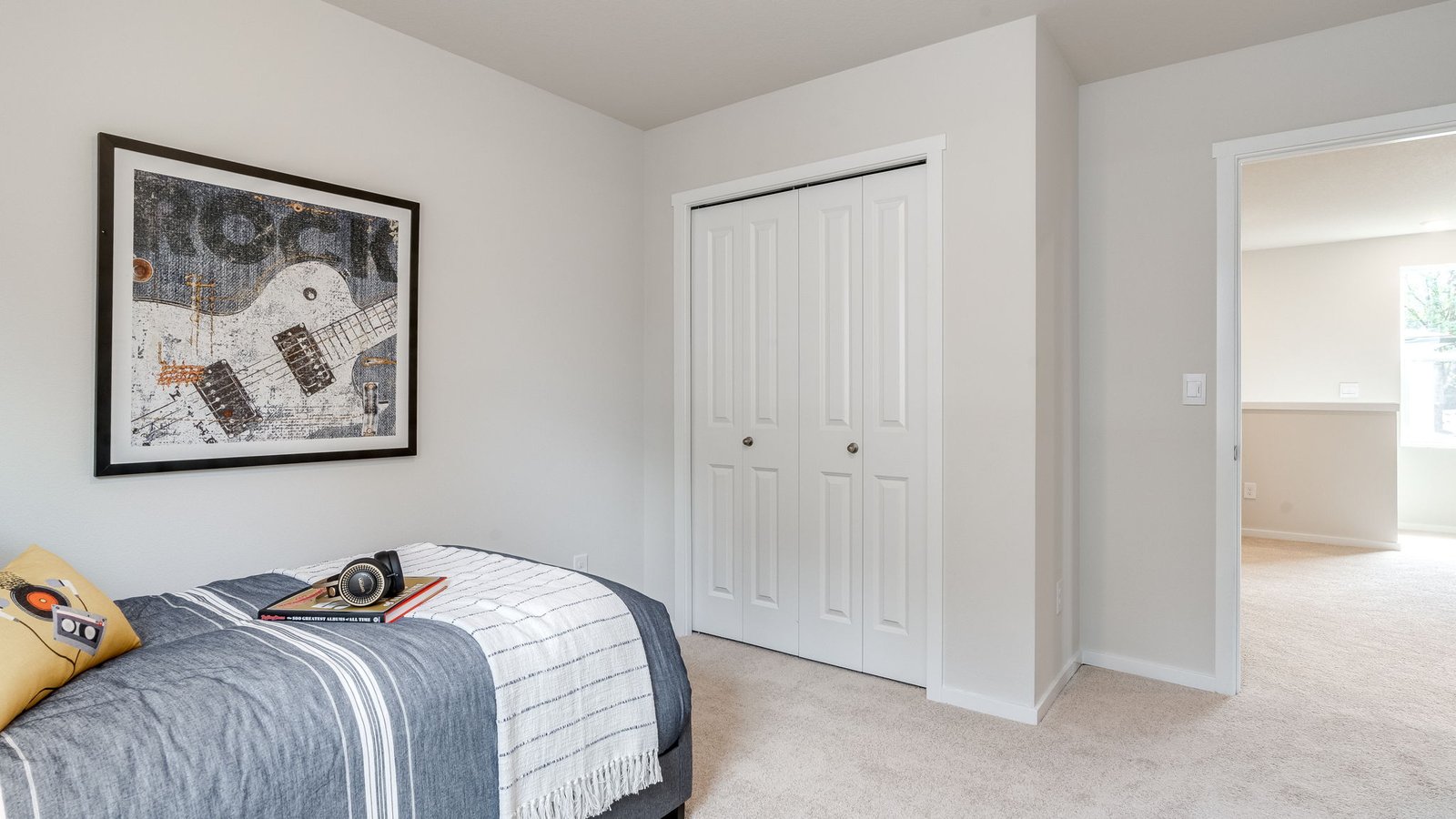 Bedroom with wall-to-wall carpet and a closet
