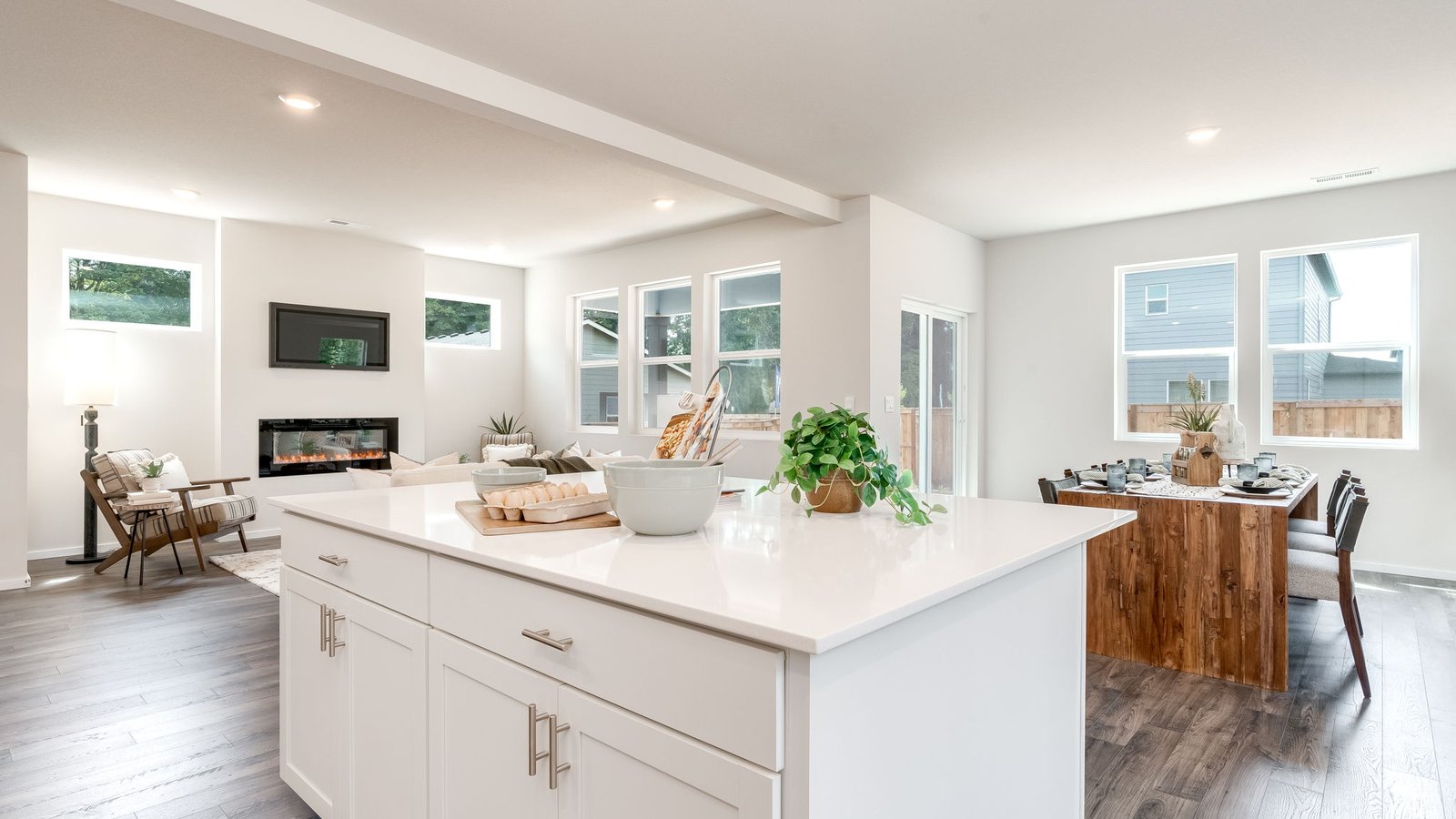 Kitchen with shaker cabinets, quartz counters, stainless steel appliances, pantry, and an island with a breakfast bar