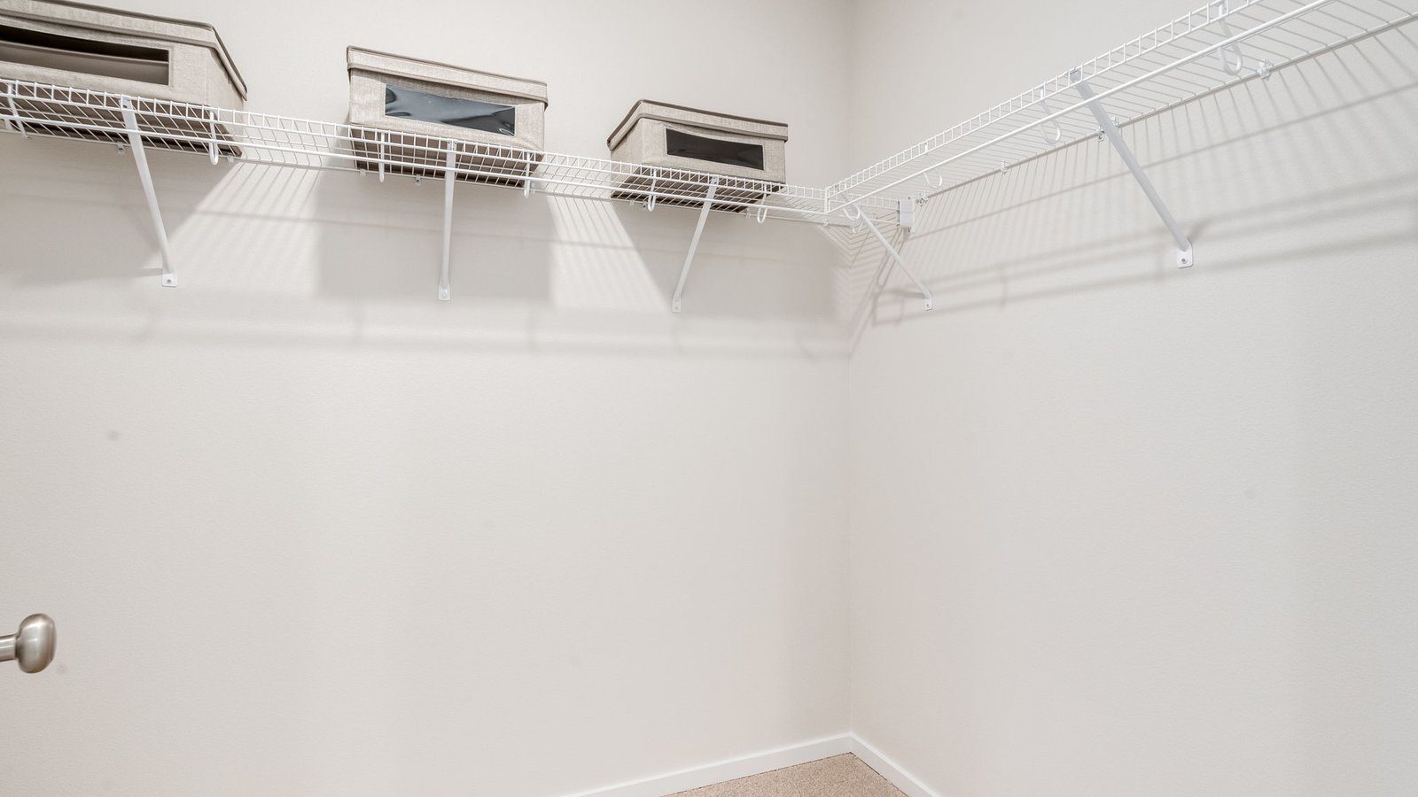 Primary bedroom walk-in closet with wire shelves