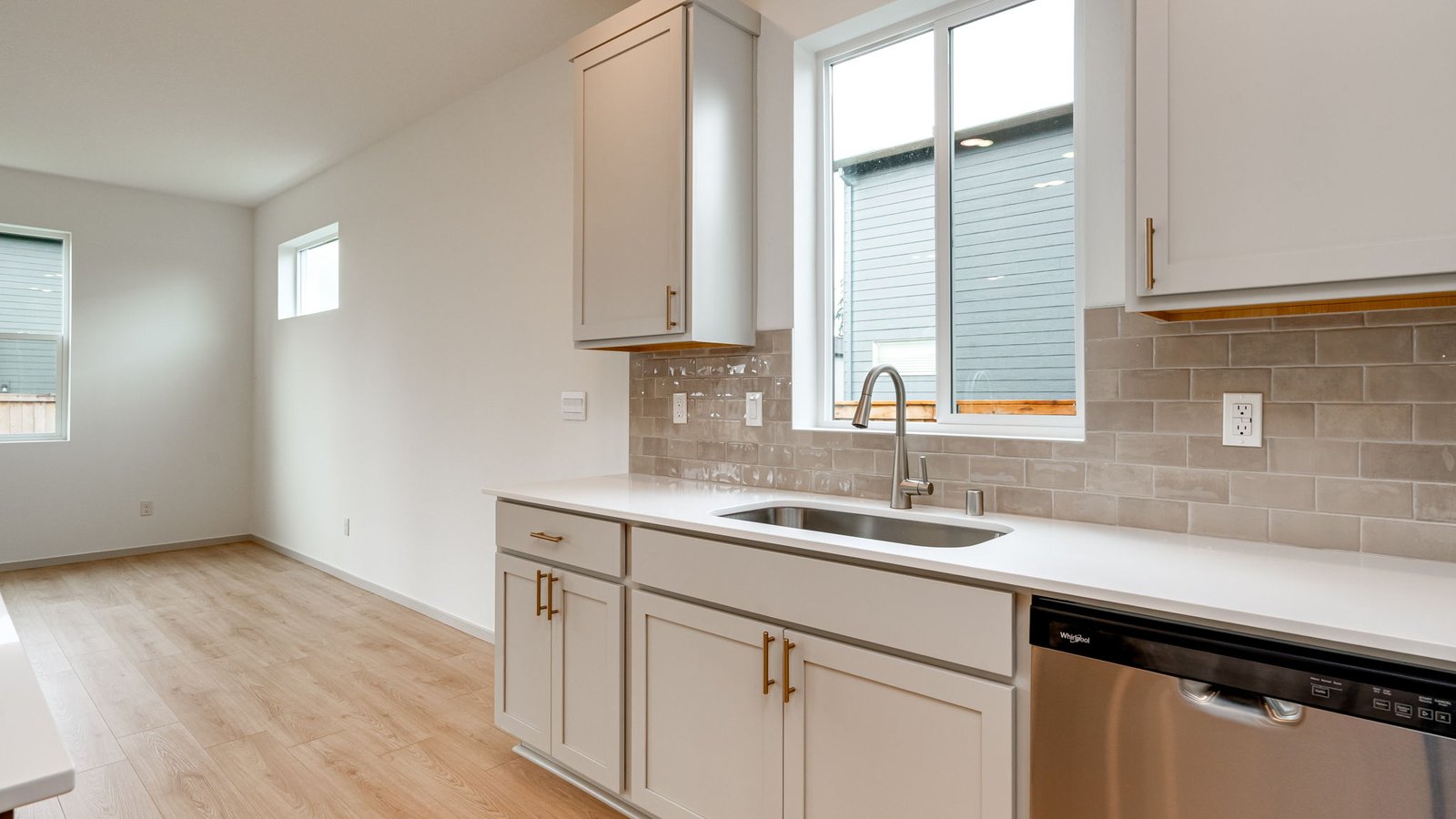 Kitchen with shaker cabinets, quartz counters, stainless steel appliances, pantry, and an island with a breakfast bar
