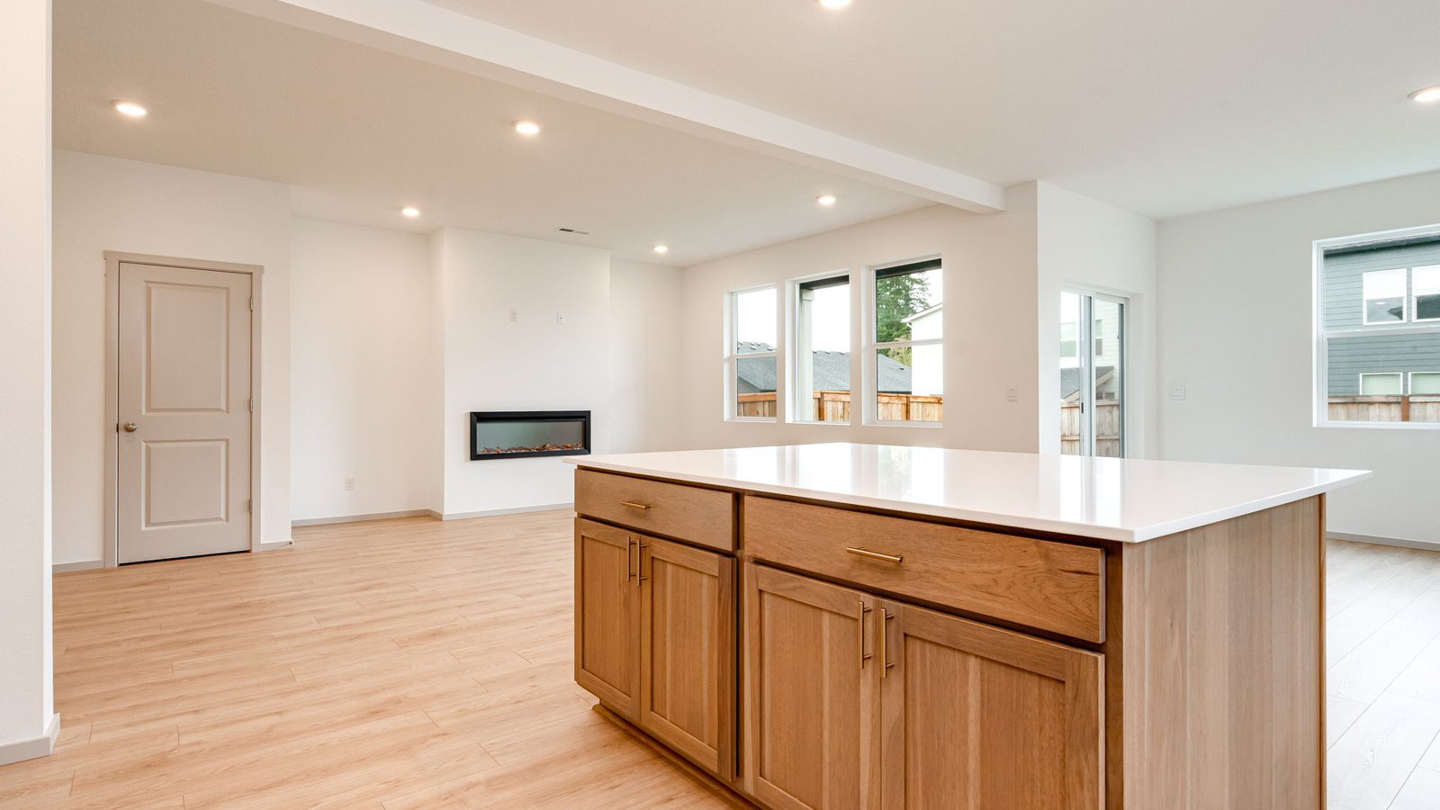 Kitchen with shaker cabinets, quartz counters, stainless steel appliances, pantry, and an island with a breakfast bar