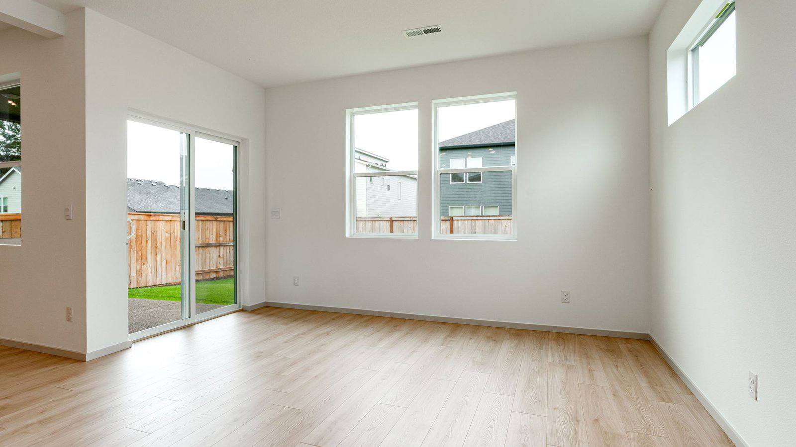 Dining area with a sliding glass door to a fenced backyard