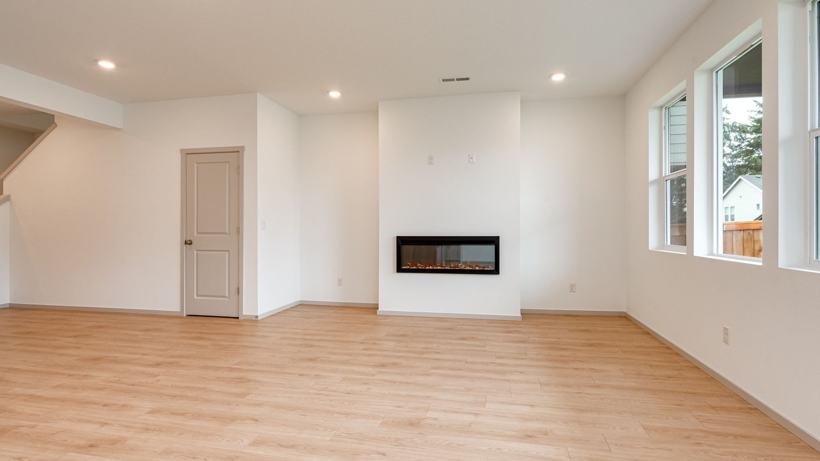 Great room with laminate flooring and an electric fireplace