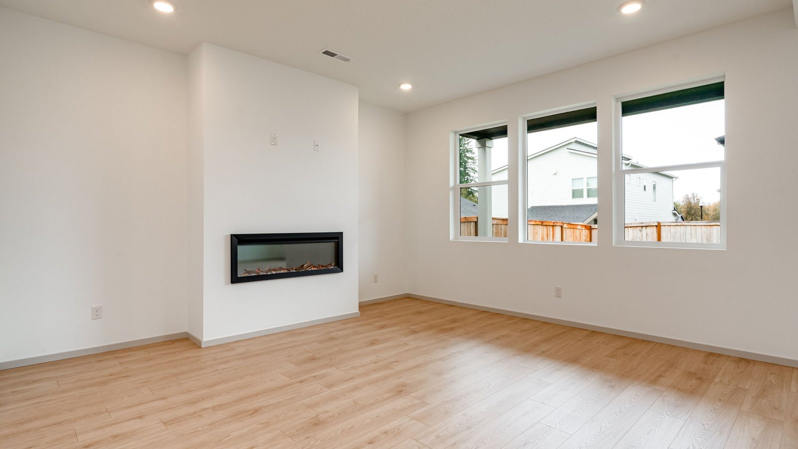 Great room with laminate flooring and an electric fireplace