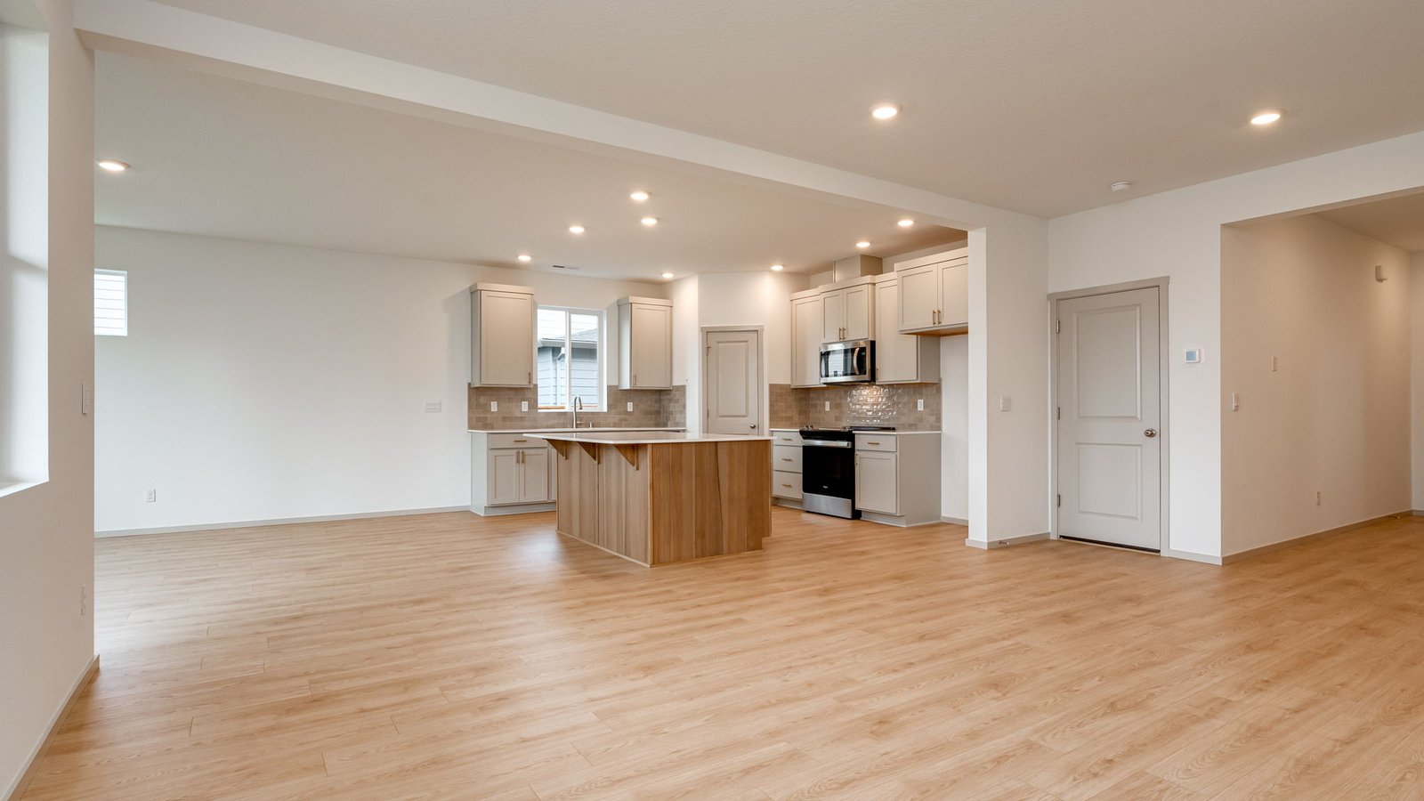 Great room with laminate flooring and an electric fireplace