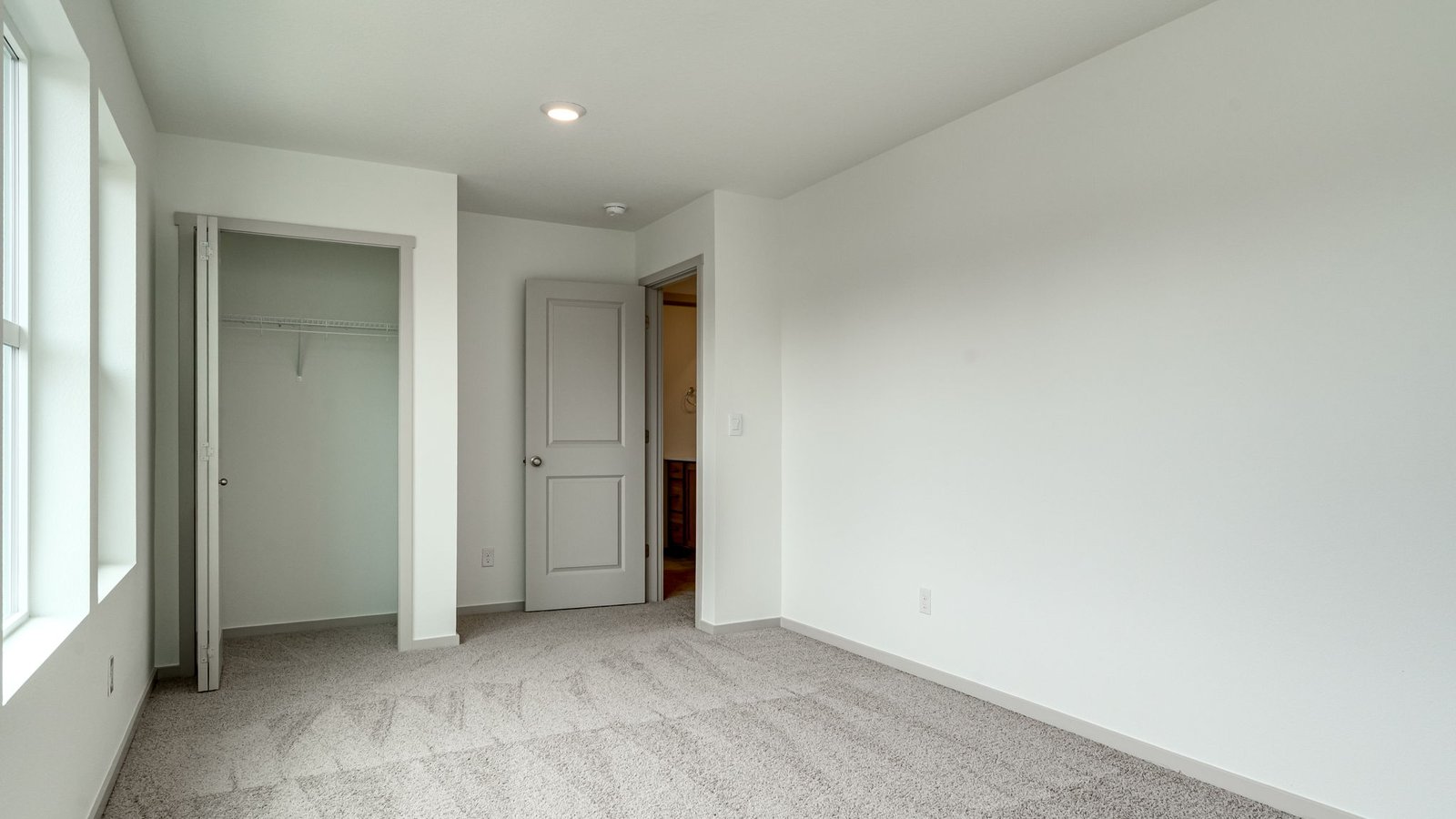 Bedroom with wall-to-wall carpet and a closet