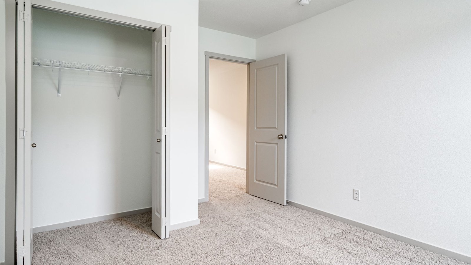 Bedroom with wall-to-wall carpet and a closet