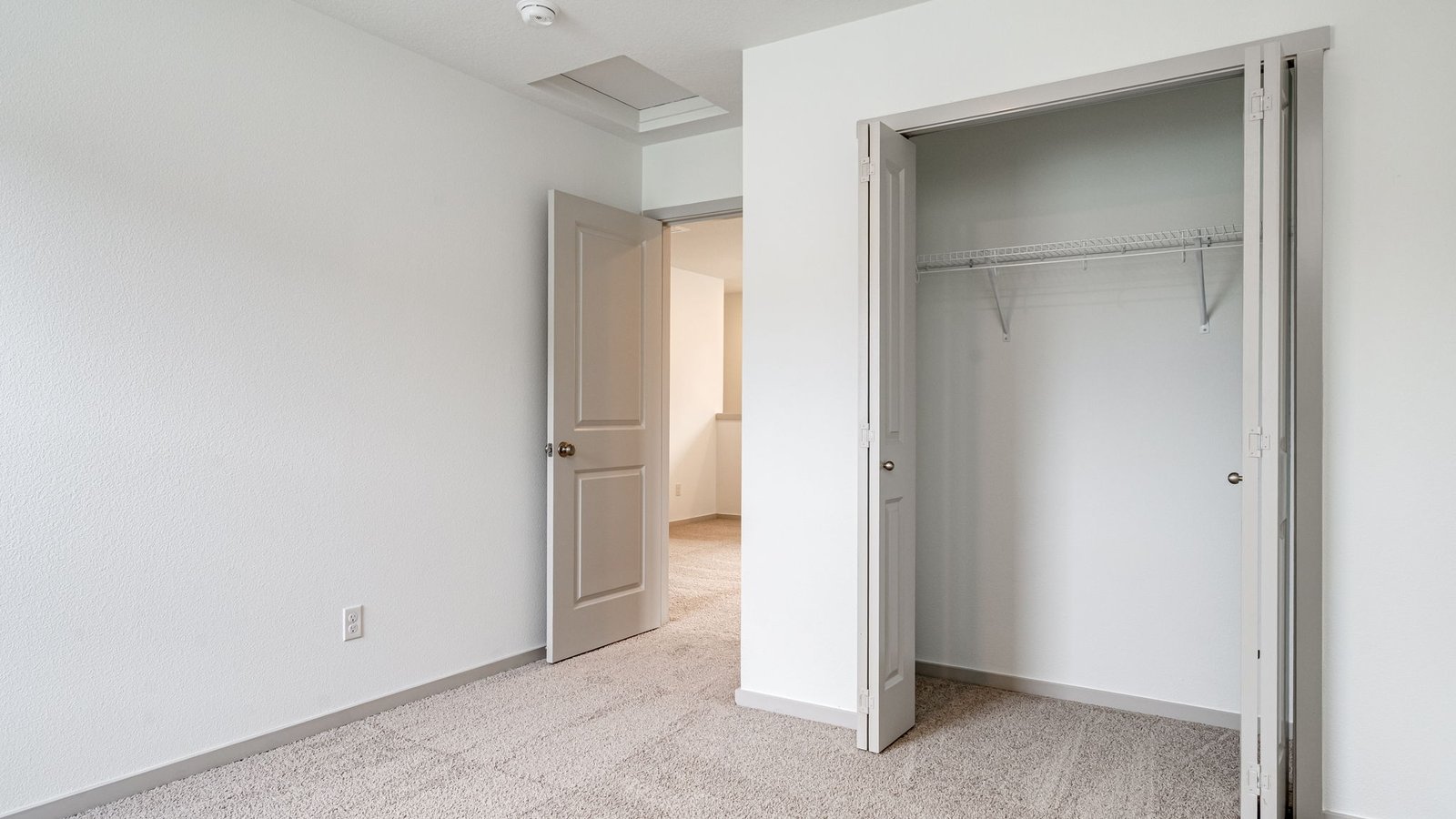 Bedroom with wall-to-wall carpet and a closet