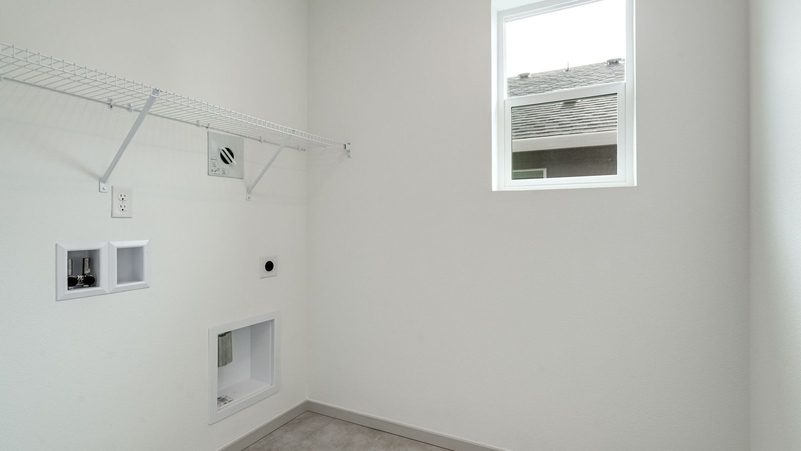 Laundry room with wire shelves and washer and dryer hookups