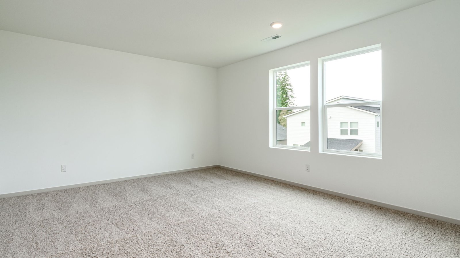 Primary bedroom with wall-to-wall carpet, a walk-in closet and an attached bathroom