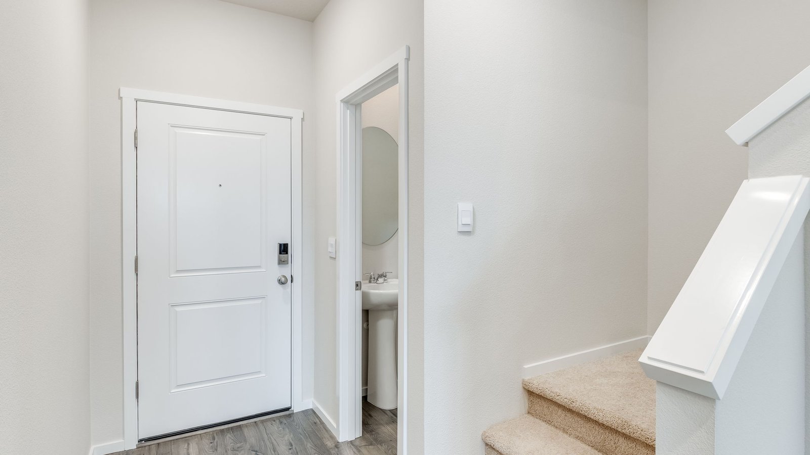 Entryway with a coat closet and laminate flooring