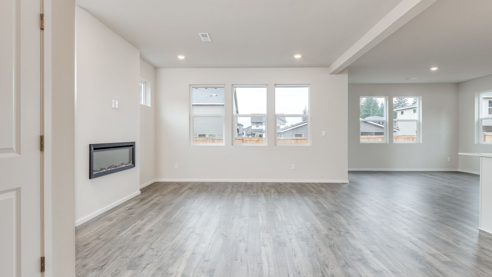 Great room with laminate flooring and an electric fireplace