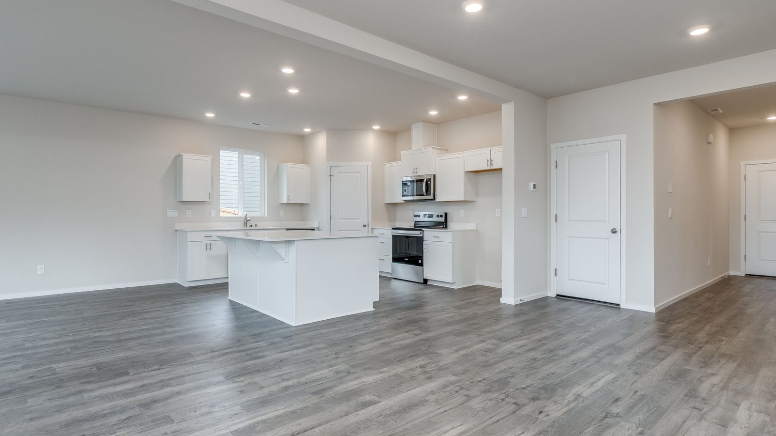 Great room with laminate flooring and an electric fireplace