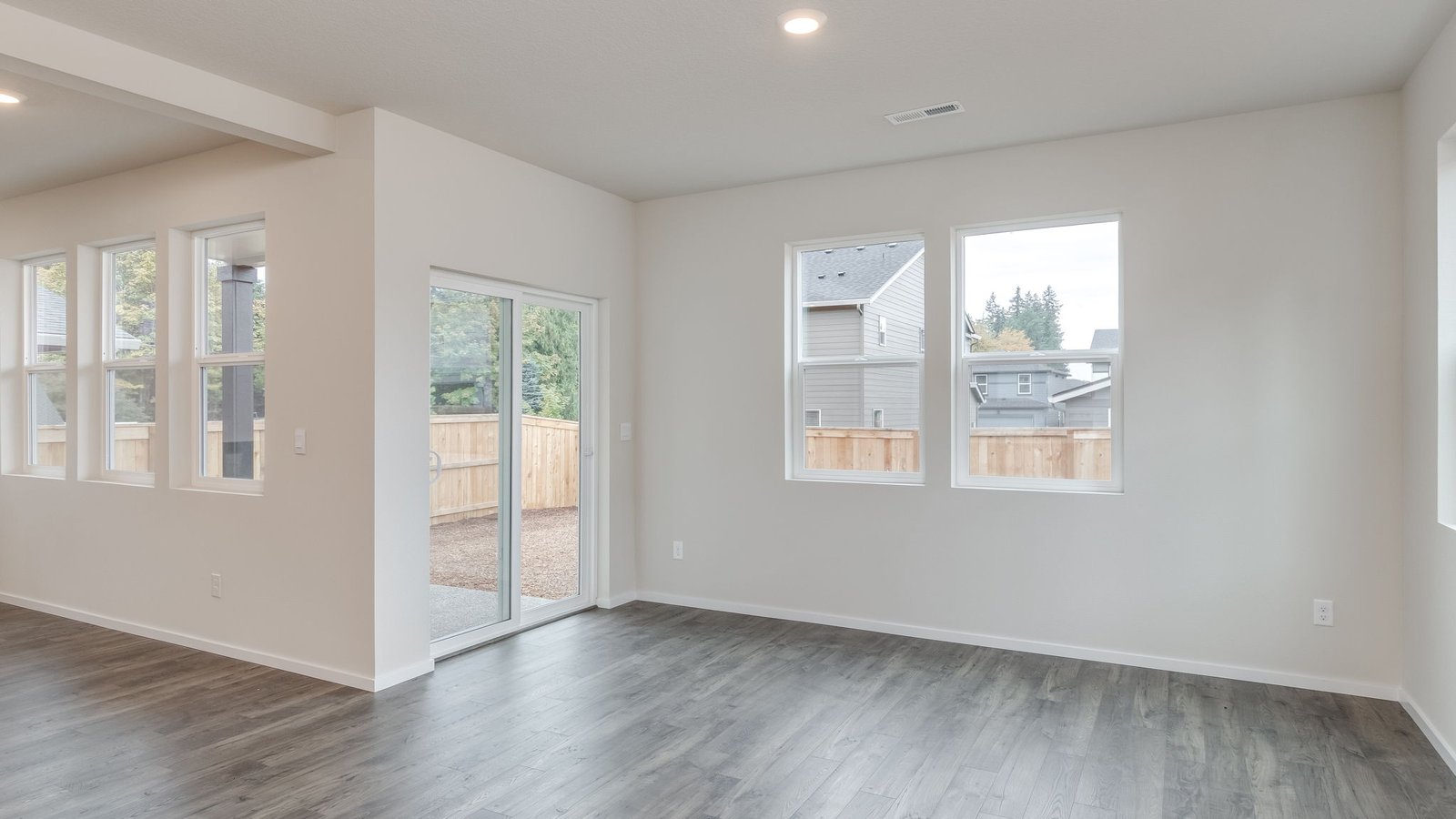 Dining area with a sliding glass door to a fenced backyard