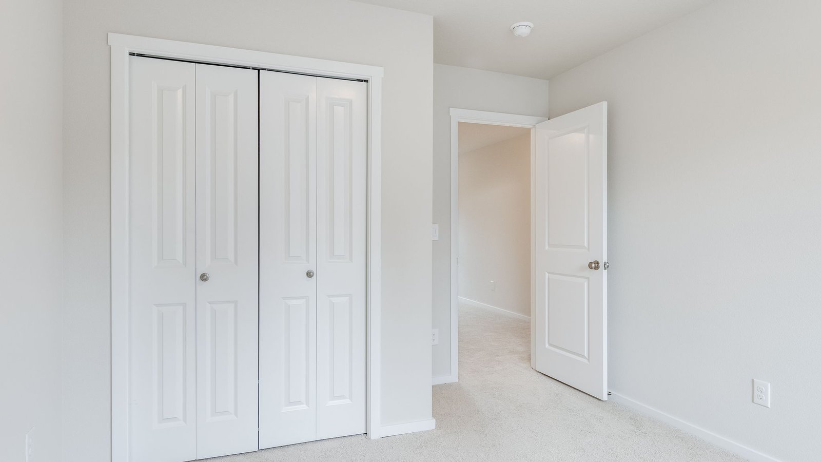 Bedroom with wall-to-wall carpet and a closet