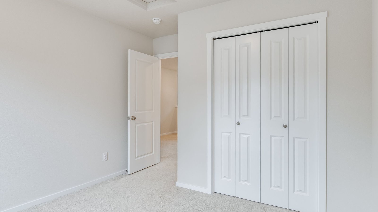 Bedroom with wall-to-wall carpet and a closet