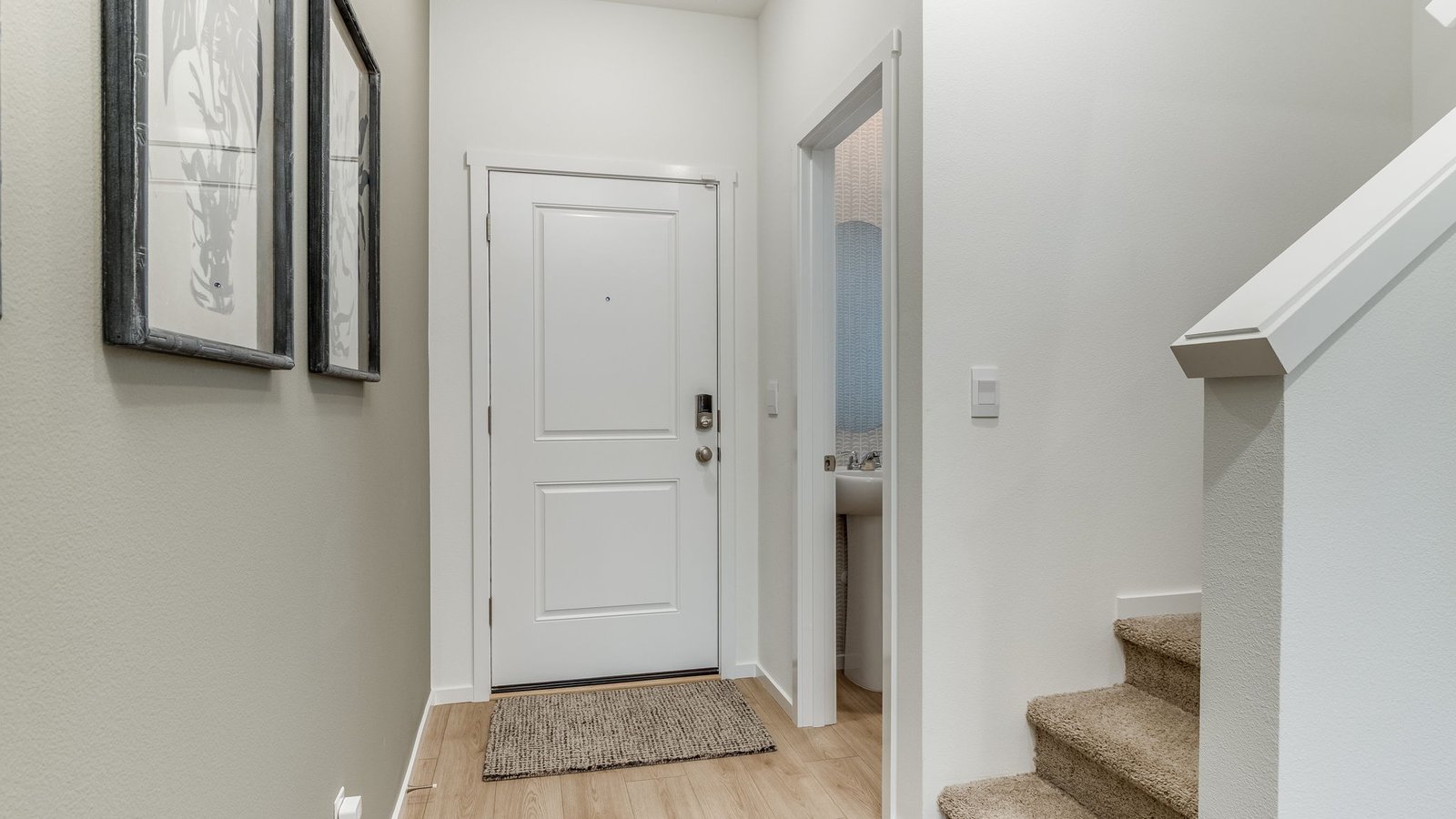 Entryway with a coat closet and laminate flooring