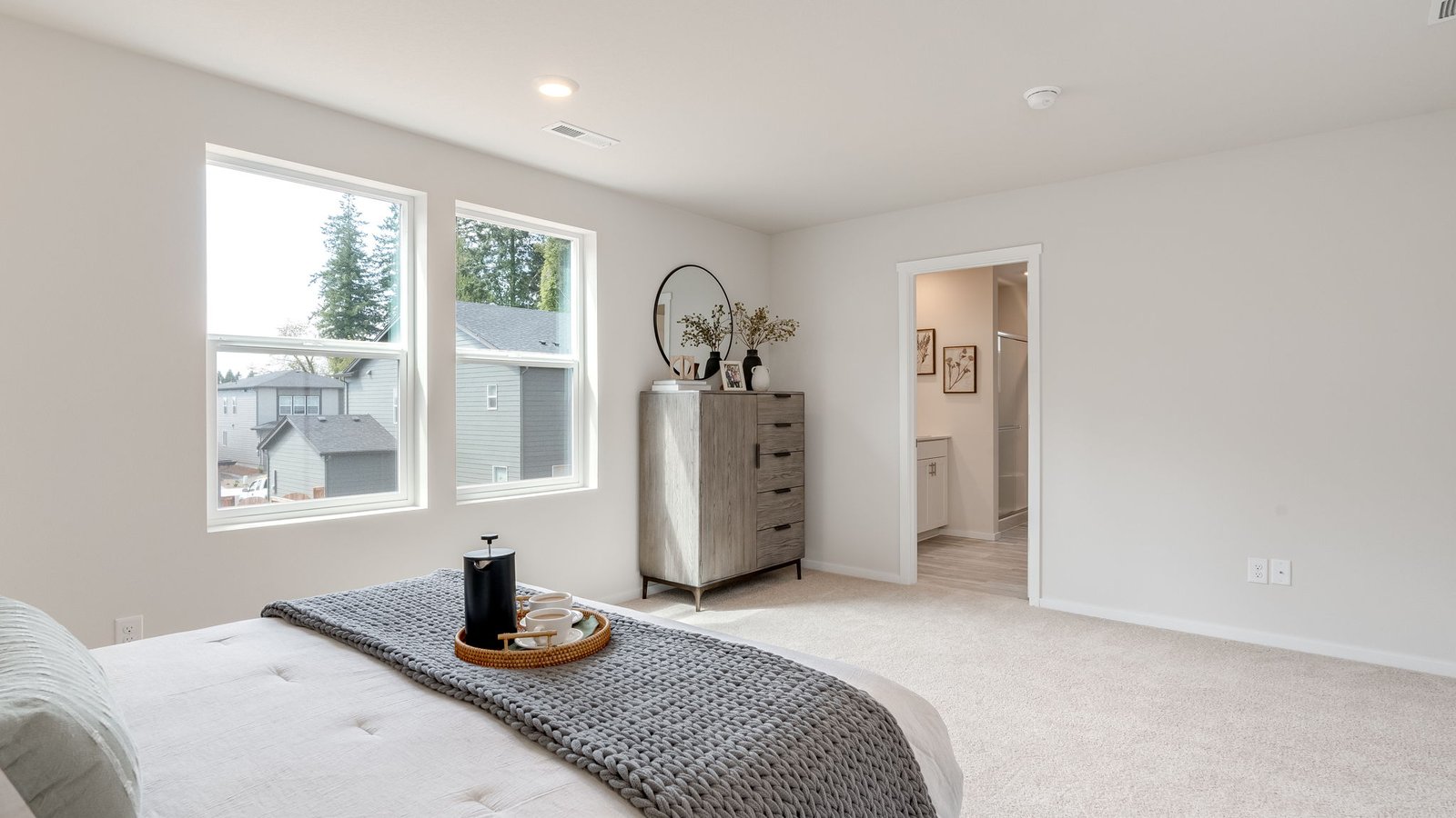 Primary bedroom with wall-to-wall carpet, a walk-in closet and an attached bathroom