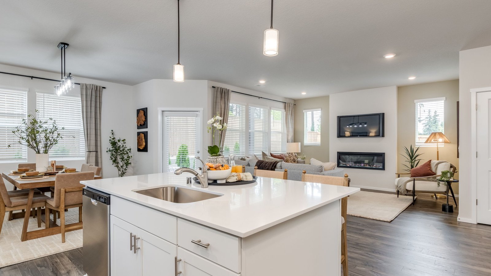 Kitchen with shaker cabinets, quartz counters, stainless steel appliances, pantry, and an island with a breakfast bar