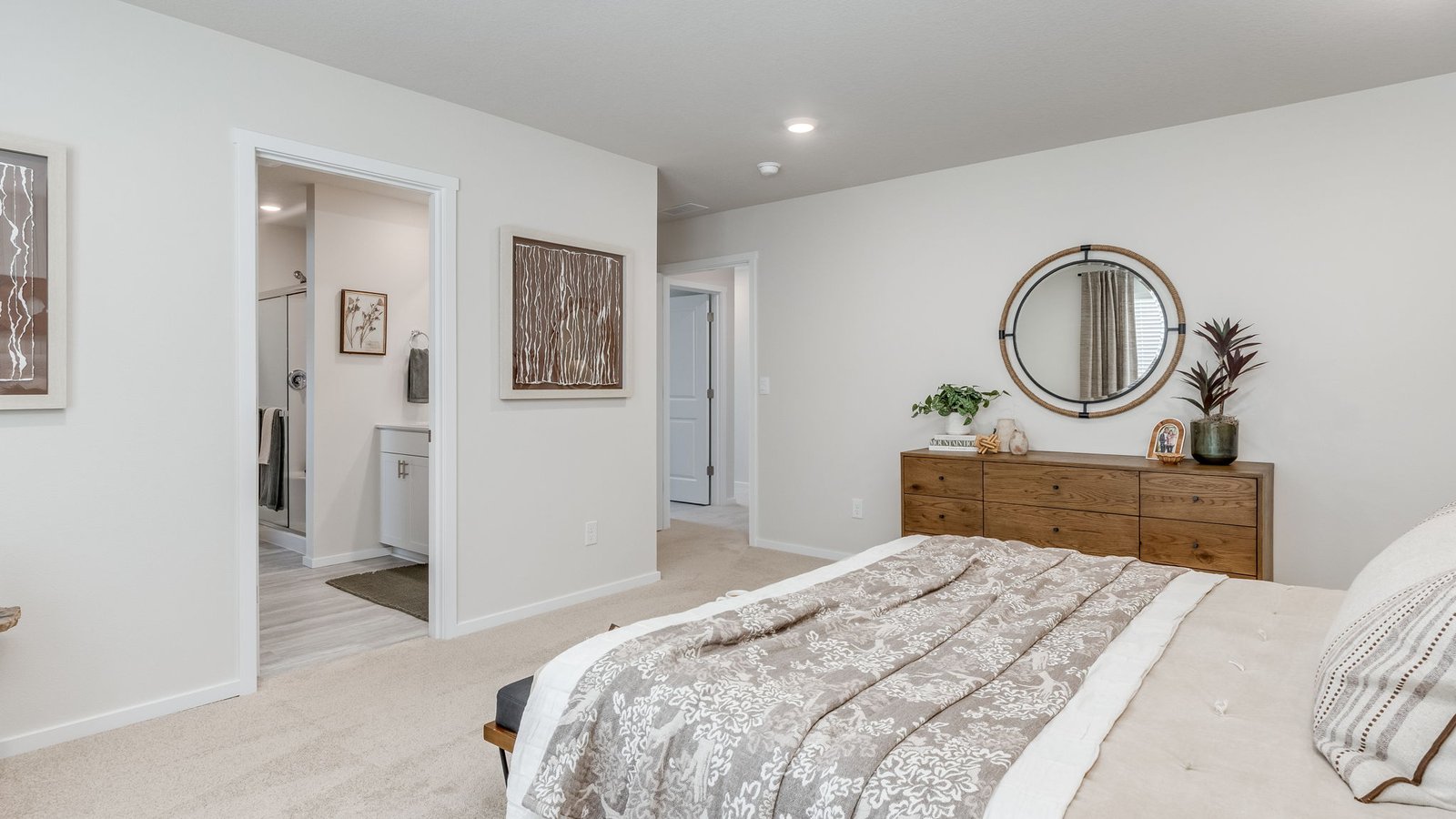 Primary bedroom with wall-to-wall carpet, a walk-in closet and an attached bathroom