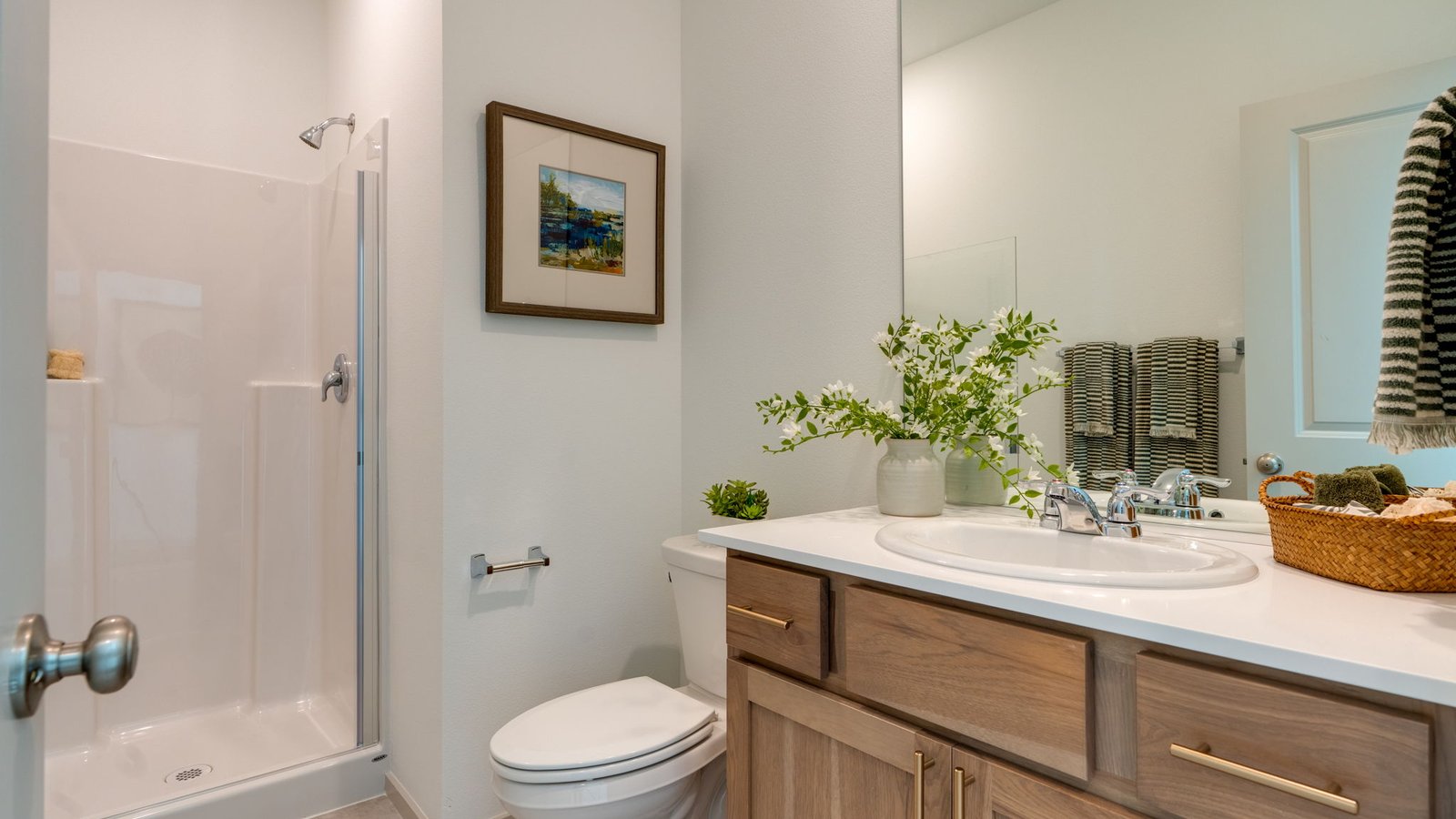 bathroom with quartz counters and a walk-in shower