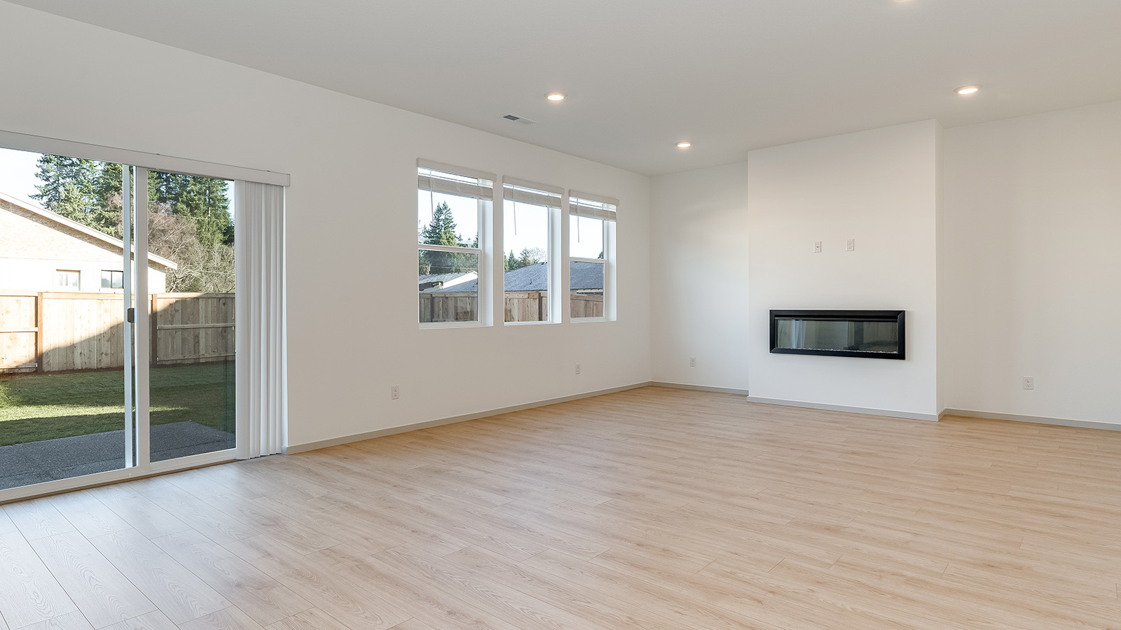 Great room with laminate flooring and an electric fireplace