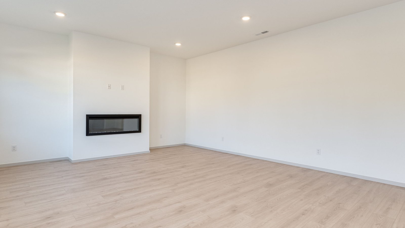 Great room with laminate flooring and an electric fireplace