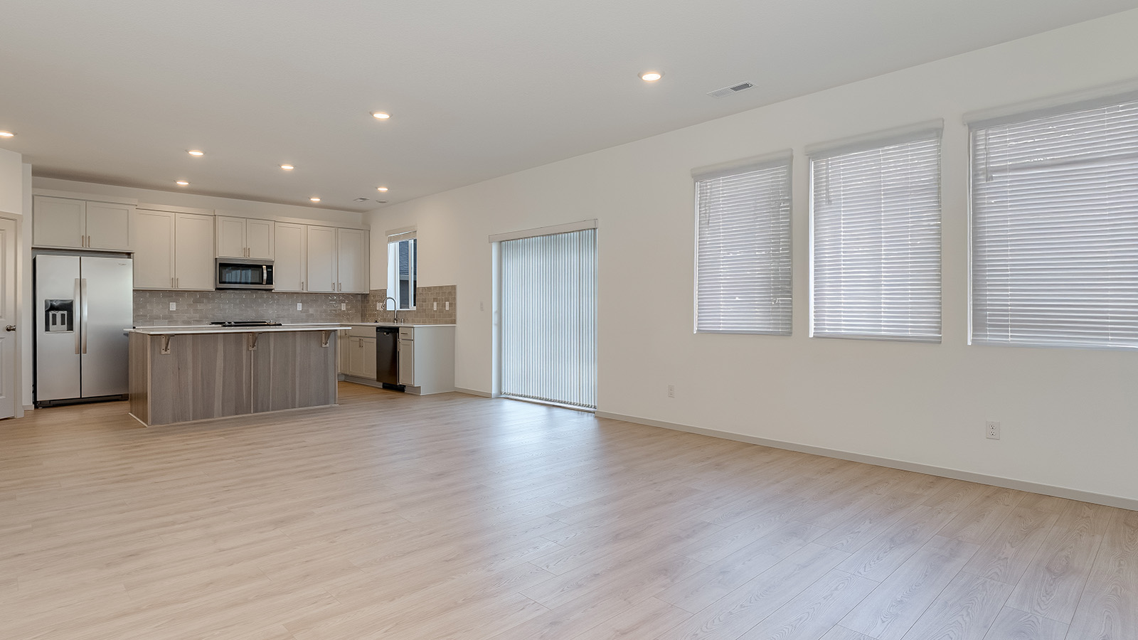 Great room with laminate flooring and an electric fireplace