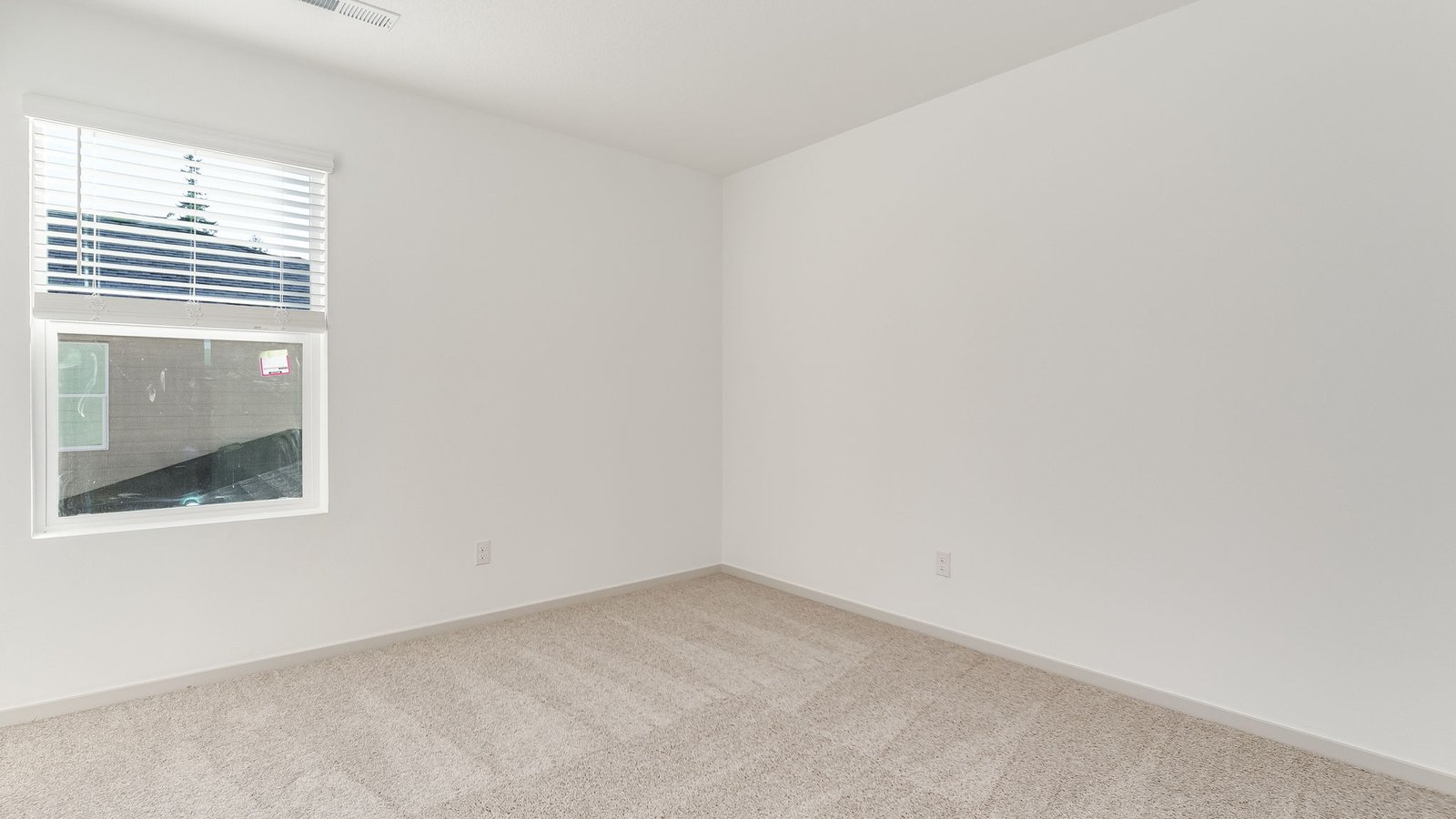 Bedroom with wall-to-wall carpet and a closet
