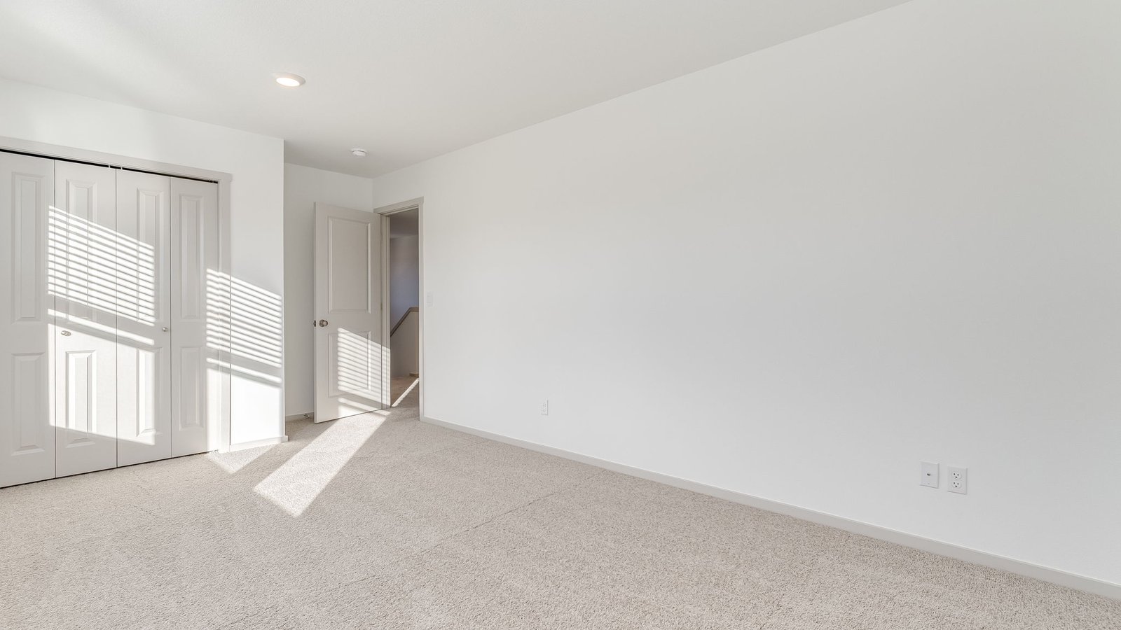 Bedroom with wall-to-wall carpet and a closet