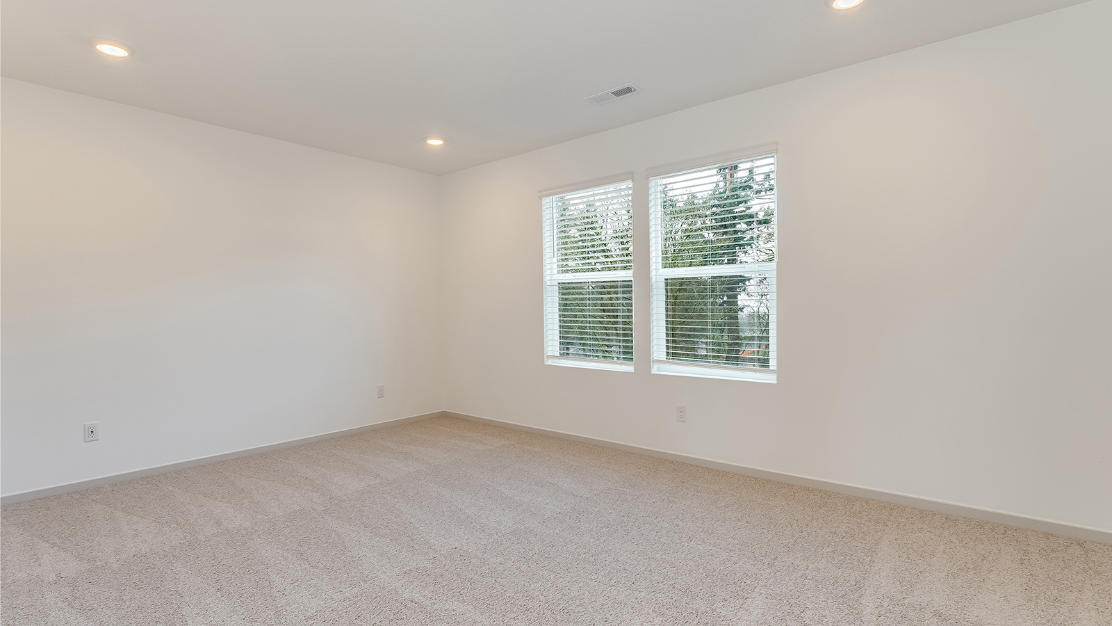 Primary bedroom with wall-to-wall carpet, a walk-in closet and an attached bathroom