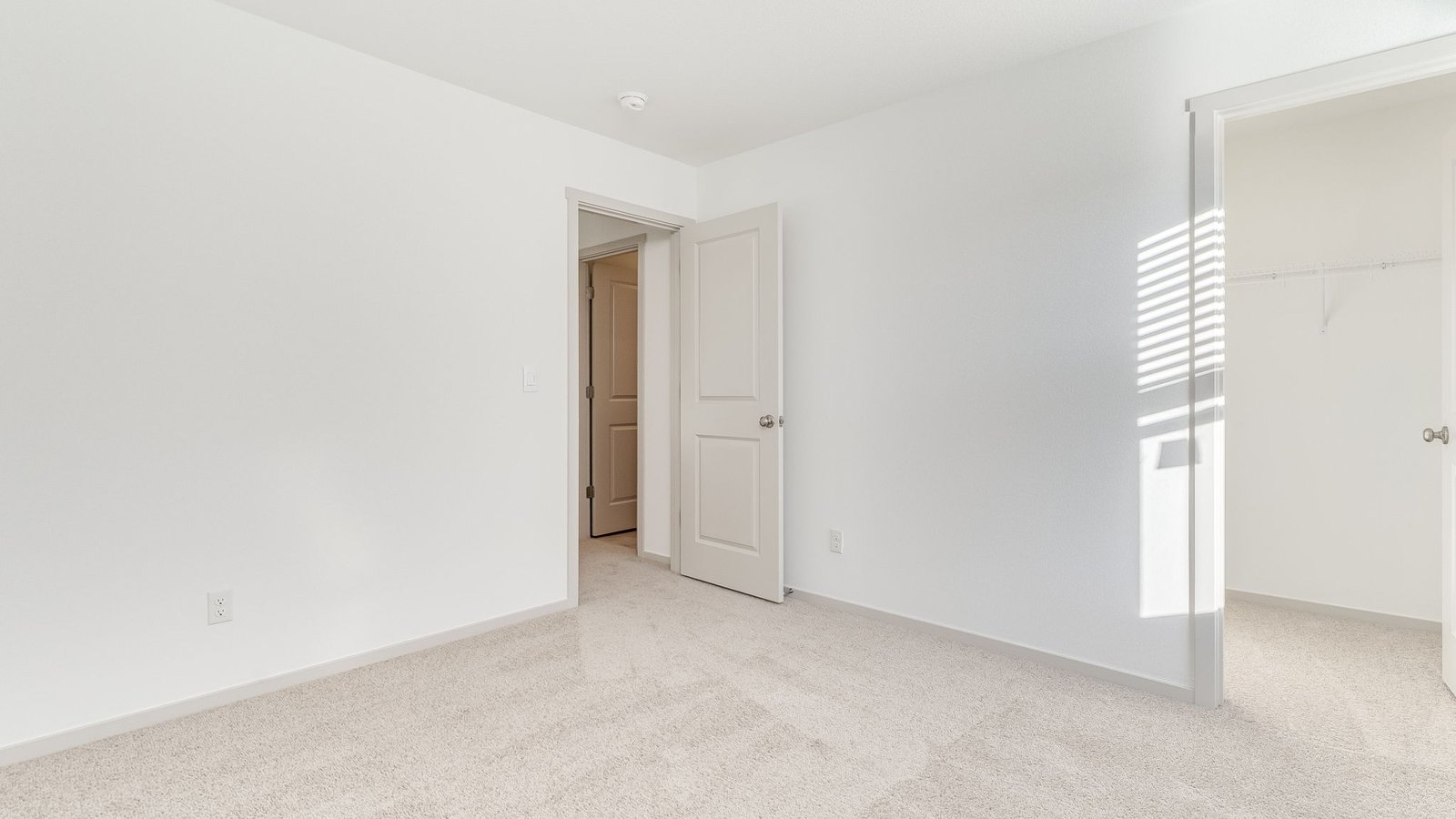 Bedroom with wall-to-wall carpet and a closet