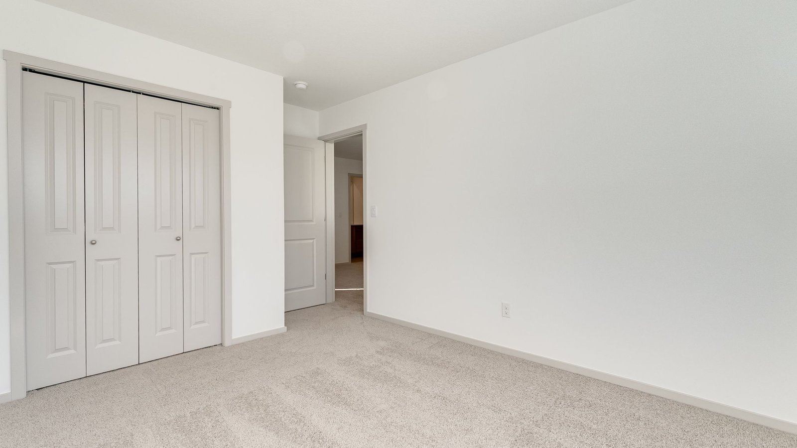 Bedroom with wall-to-wall carpet and a closet