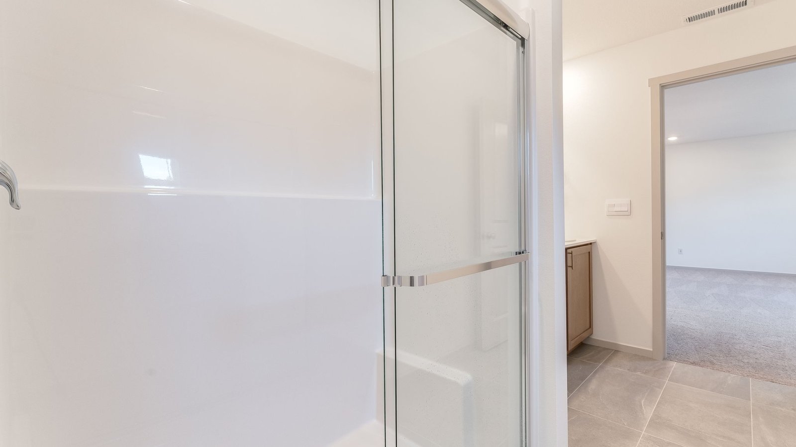 Primary bathroom with quartz counters and a walk-in shower