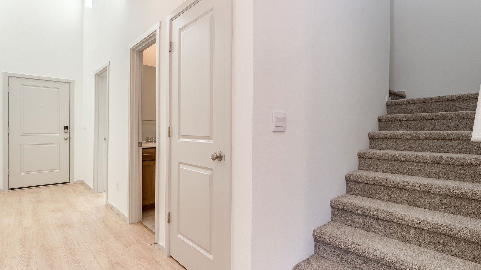 Entryway with a coat closet and laminate flooring