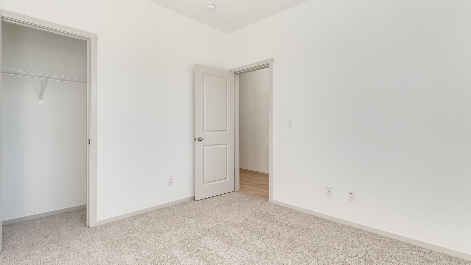 Bedroom with wall-to-wall carpet and a closet