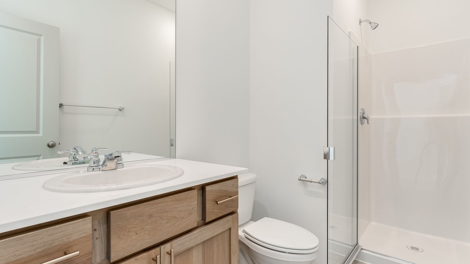 bathroom with quartz counters and a walk-in shower