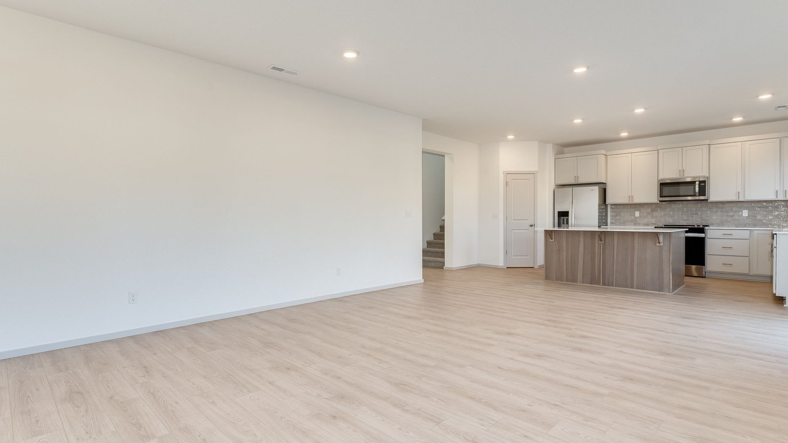 Great room with laminate flooring and an electric fireplace