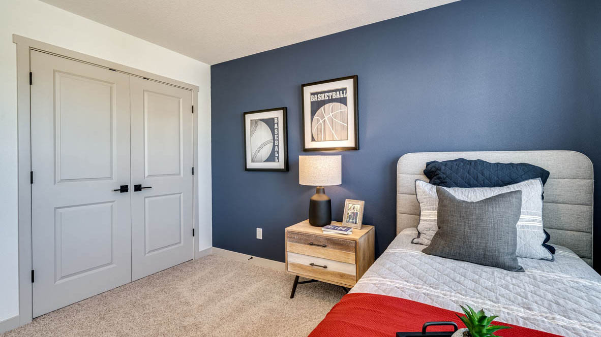 Bedroom with wall-to-wall carpet and a closet