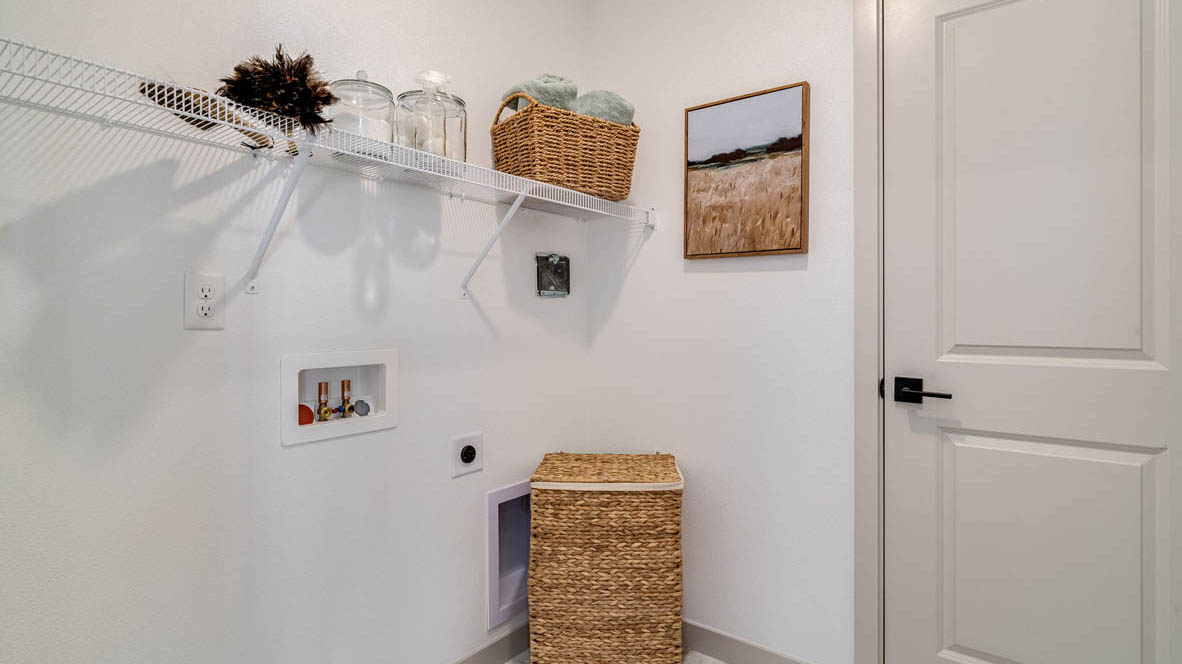Laundry room with wire shelves and washer and dryer hookups