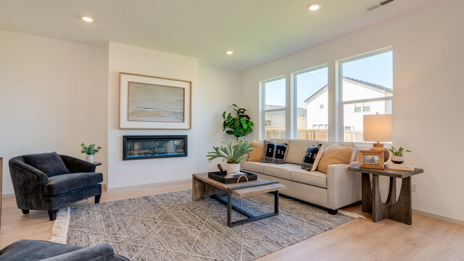 Great room with laminate flooring and an electric fireplace
